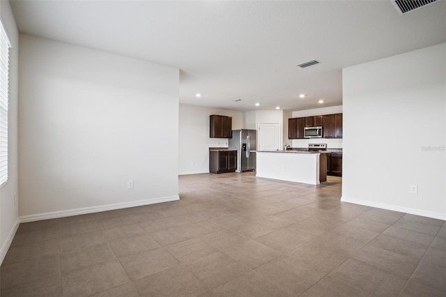 17127 Harvest Moon Way, Bradenton, FL 34211 - unfurnished living room with recessed lighting and tile patterned floors