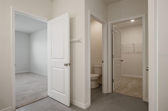 17127 Harvest Moon Way, Bradenton, FL 34211 - bathroom featuring tile patterned floors and a walk in closet