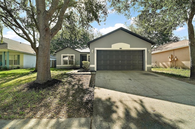 979 Mayfair St, Eustis, FL 32726 - ranch-style home with stucco siding, driveway, an attached garage, and a front yard