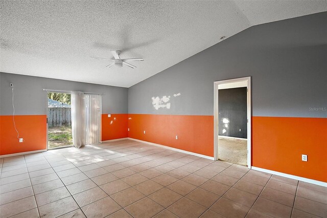 979 Mayfair St, Eustis, FL 32726 - unfurnished room with vaulted ceiling, ceiling fan, tile patterned flooring, and a textured ceiling