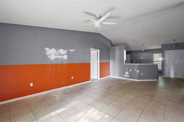 979 Mayfair St, Eustis, FL 32726 - unfurnished living room featuring ceiling fan, light tile patterned floors, lofted ceiling, and a textured ceiling