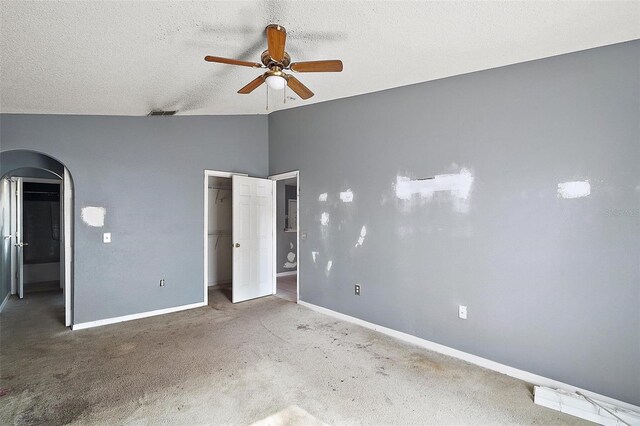 979 Mayfair St, Eustis, FL 32726 - unfurnished bedroom featuring arched walkways, lofted ceiling, carpet flooring, a closet, and a spacious closet