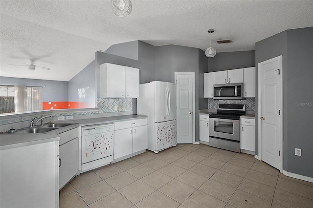 979 Mayfair St, Eustis, FL 32726 - kitchen with appliances with stainless steel finishes, decorative backsplash, a textured ceiling, a ceiling fan, and white cabinetry