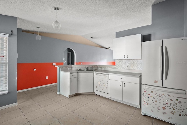 979 Mayfair St, Eustis, FL 32726 - kitchen with white appliances, white cabinetry, a peninsula, vaulted ceiling, and hanging light fixtures