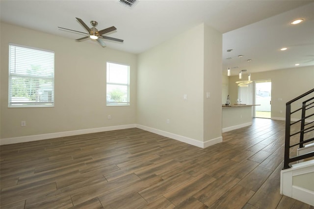 1222 Castlevecchio Loop, Orlando, FL 32825 - unfurnished room featuring dark wood-style flooring, healthy amount of natural light, ceiling fan, recessed lighting, and stairway