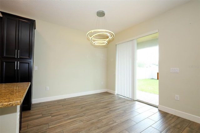 1222 Castlevecchio Loop, Orlando, FL 32825 - unfurnished dining area featuring a chandelier and light wood-style flooring