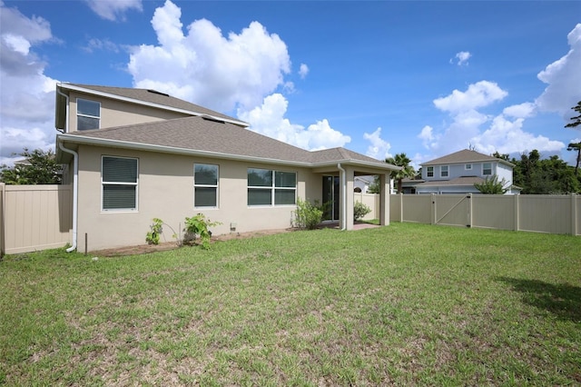 1222 Castlevecchio Loop, Orlando, FL 32825 - back of property featuring a fenced backyard, stucco siding, and roof with shingles