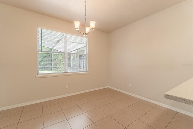 1129 Royal Ridge Dr, Davenport, FL 33896 - empty room featuring light tile patterned flooring and a chandelier