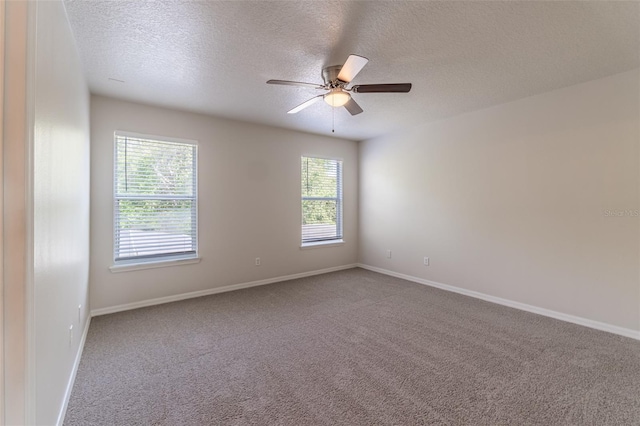 1129 Royal Ridge Dr, Davenport, FL 33896 - empty room with a textured ceiling, healthy amount of natural light, carpet floors, and ceiling fan