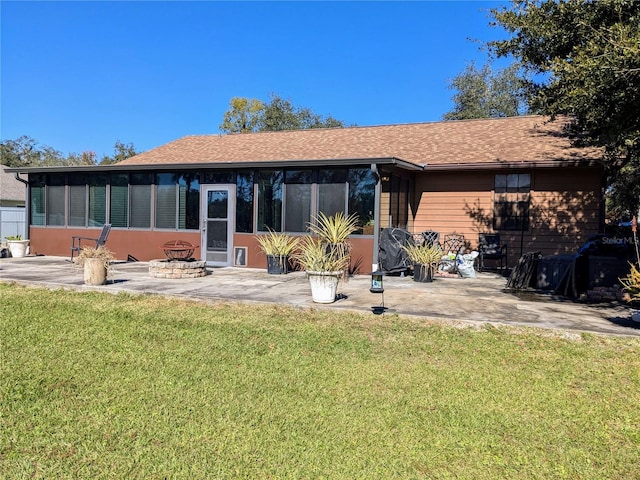 3021 Norvell Ct, Deltona, FL 32738 - back of property with a sunroom, a patio area, a lawn, and roof with shingles