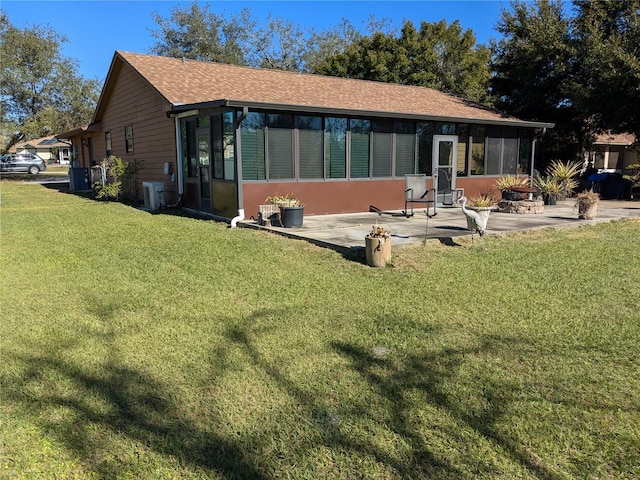 3021 Norvell Ct, Deltona, FL 32738 - back of property featuring a sunroom, a lawn, and a patio area