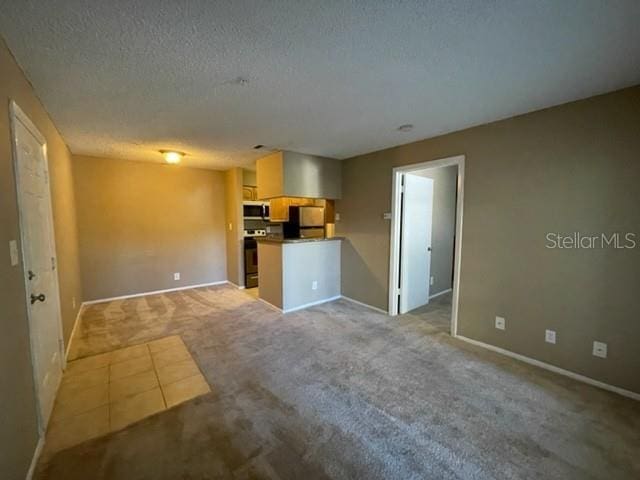 236 Afton Sq Unit 207, Altamonte Springs, FL 32714 - unfurnished living room with light colored carpet and a textured ceiling