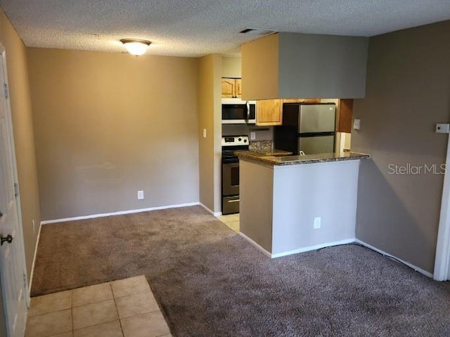 236 Afton Sq Unit 207, Altamonte Springs, FL 32714 - kitchen with stainless steel appliances, light colored carpet, a textured ceiling, and a peninsula