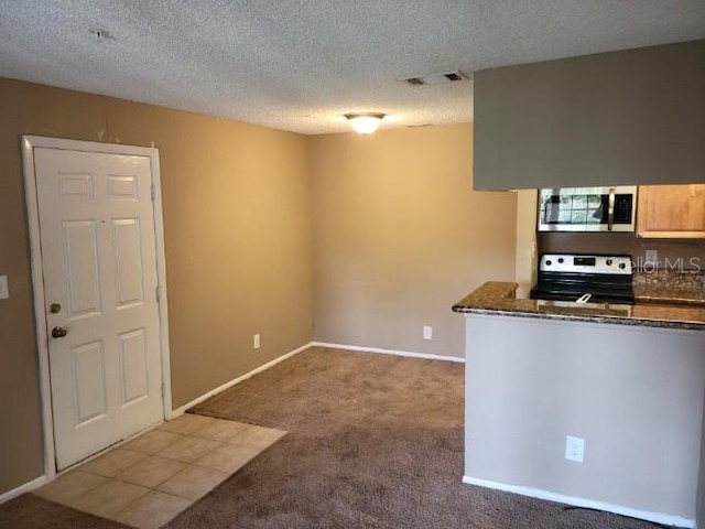 236 Afton Sq Unit 207, Altamonte Springs, FL 32714 - kitchen with stainless steel microwave, range with electric stovetop, carpet, and a textured ceiling