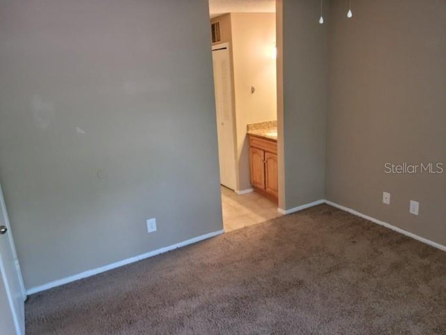 236 Afton Sq Unit 207, Altamonte Springs, FL 32714 - unfurnished bedroom with light colored carpet and baseboards