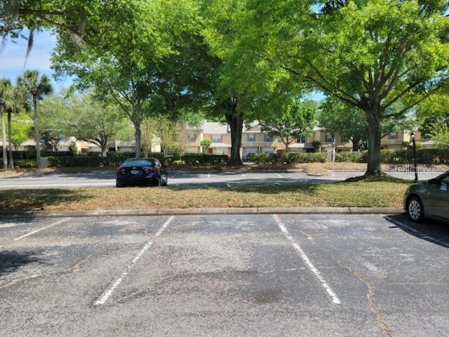236 Afton Sq Unit 207, Altamonte Springs, FL 32714 - uncovered parking lot featuring a residential view