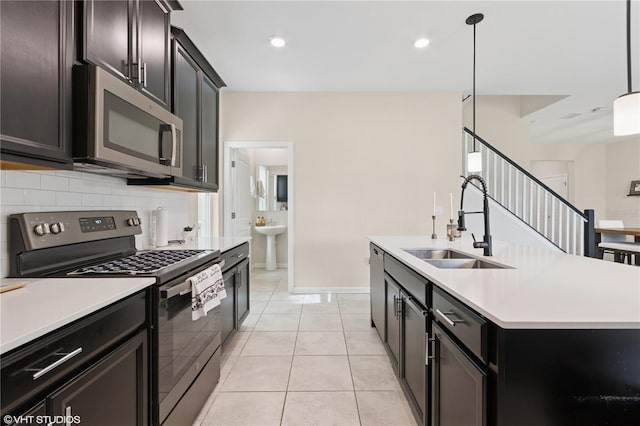 8955 Fluffy Lie Ct, Davenport, FL 33896 - kitchen featuring appliances with stainless steel finishes, decorative backsplash, light countertops, a center island with sink, and recessed lighting