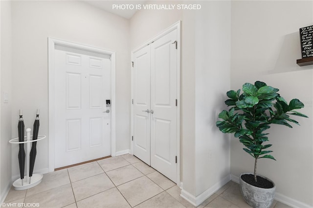 8955 Fluffy Lie Ct, Davenport, FL 33896 - foyer entrance featuring light tile patterned floors and baseboards