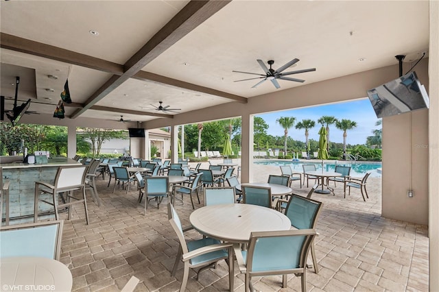 8955 Fluffy Lie Ct, Davenport, FL 33896 - view of patio / terrace featuring ceiling fan, a community pool, outdoor dining space, and a bar