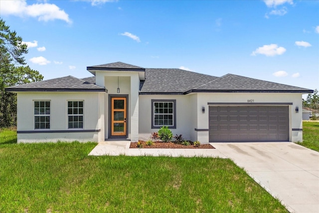 6421 SW 151st Loop, Ocala, FL 34473 - prairie-style house featuring an attached garage, stucco siding, and a shingled roof