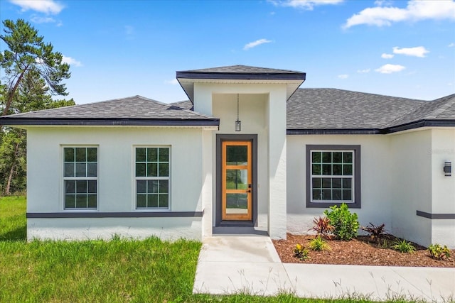 6421 SW 151st Loop, Ocala, FL 34473 - view of exterior entry featuring a shingled roof and stucco siding