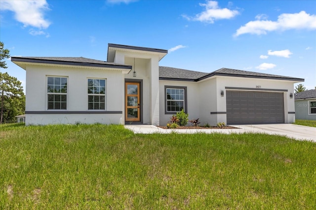 6421 SW 151st Loop, Ocala, FL 34473 - prairie-style home featuring a garage, stucco siding, concrete driveway, a front lawn, and roof with shingles