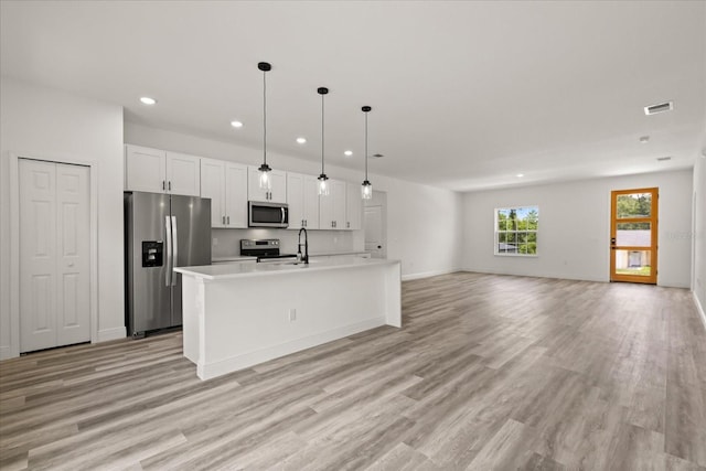 6421 SW 151st Loop, Ocala, FL 34473 - kitchen featuring stainless steel appliances, recessed lighting, light countertops, light wood-style flooring, and white cabinets