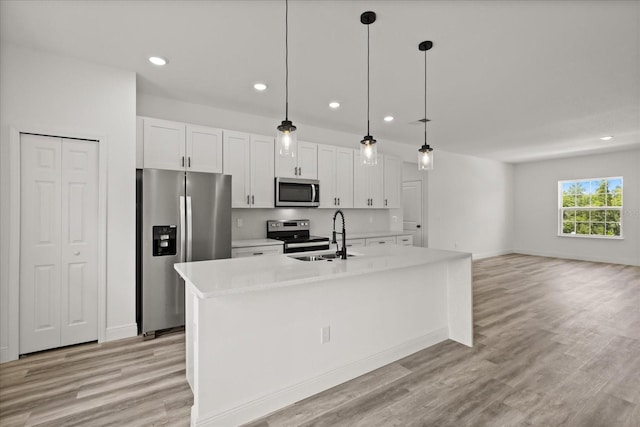6421 SW 151st Loop, Ocala, FL 34473 - kitchen featuring stainless steel appliances, white cabinets, recessed lighting, a kitchen island with sink, and light countertops