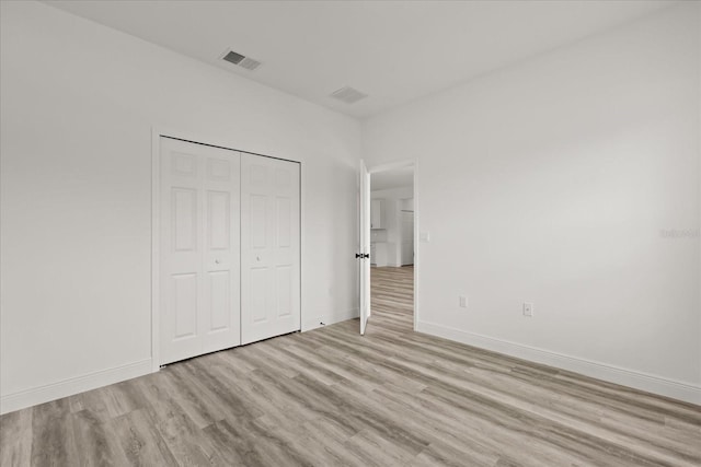 6421 SW 151st Loop, Ocala, FL 34473 - unfurnished bedroom with light wood-style flooring and a closet