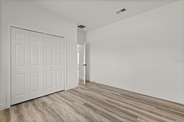 6421 SW 151st Loop, Ocala, FL 34473 - unfurnished bedroom with light wood-type flooring and a closet