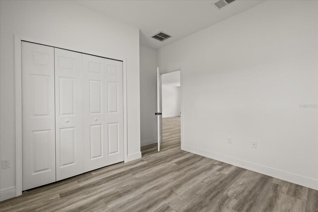 6421 SW 151st Loop, Ocala, FL 34473 - unfurnished bedroom with wood finished floors and a closet