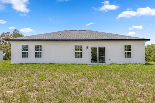6421 SW 151st Loop, Ocala, FL 34473 - back of house with a yard, a shingled roof, and stucco siding