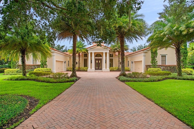 3426 Cocard Ct, Windermere, FL 34786 - view of front of house with a garage, decorative driveway, french doors, stucco siding, and a front yard