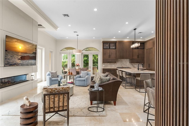 3426 Cocard Ct, Windermere, FL 34786 - living area featuring a glass covered fireplace, recessed lighting, ornamental molding, and french doors