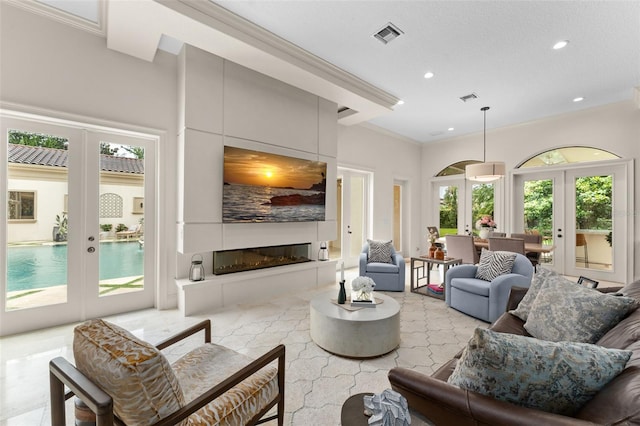 3426 Cocard Ct, Windermere, FL 34786 - living area with french doors, recessed lighting, ornamental molding, and a fireplace
