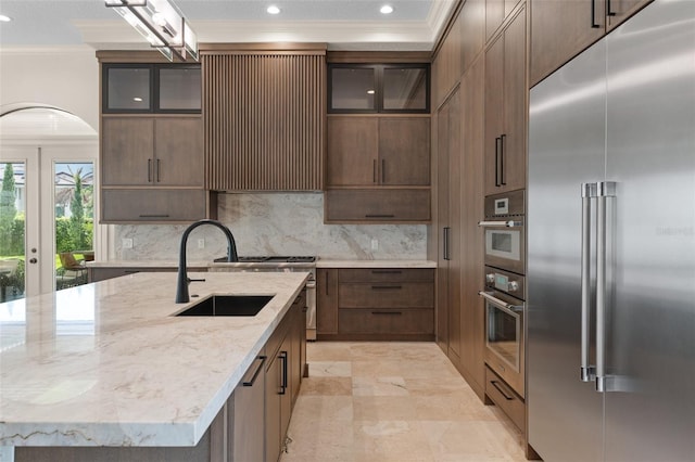 3426 Cocard Ct, Windermere, FL 34786 - kitchen featuring high quality appliances, crown molding, recessed lighting, tasteful backsplash, and a center island with sink