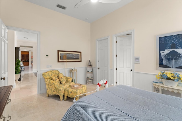 3426 Cocard Ct, Windermere, FL 34786 - bedroom with a wainscoted wall, light tile patterned floors, and a ceiling fan