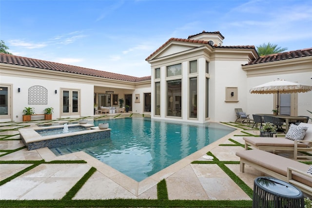 3426 Cocard Ct, Windermere, FL 34786 - view of swimming pool featuring french doors, a pool with connected hot tub, a patio, and outdoor dining area
