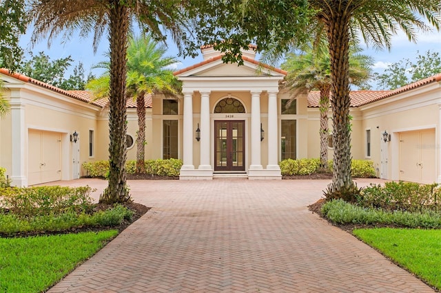 3426 Cocard Ct, Windermere, FL 34786 - view of front of house featuring french doors, decorative driveway, and stucco siding