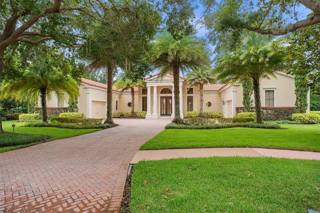 3426 Cocard Ct, Windermere, FL 34786 - mediterranean / spanish-style house featuring decorative driveway, a front yard, stucco siding, and french doors
