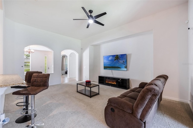 2782 Cedar Knoll Dr, Apopka, FL 32712 - carpeted living room featuring arched walkways, ceiling fan, and a chandelier