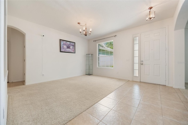 2782 Cedar Knoll Dr, Apopka, FL 32712 - entryway featuring arched walkways, a chandelier, light carpet, and light tile patterned floors