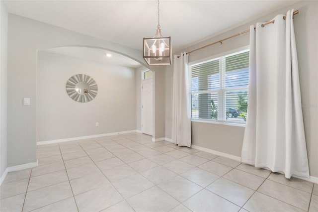 6808 Cranes Roost Rd, Harmony, FL 34773 - unfurnished dining area featuring arched walkways, a chandelier, and light tile patterned floors
