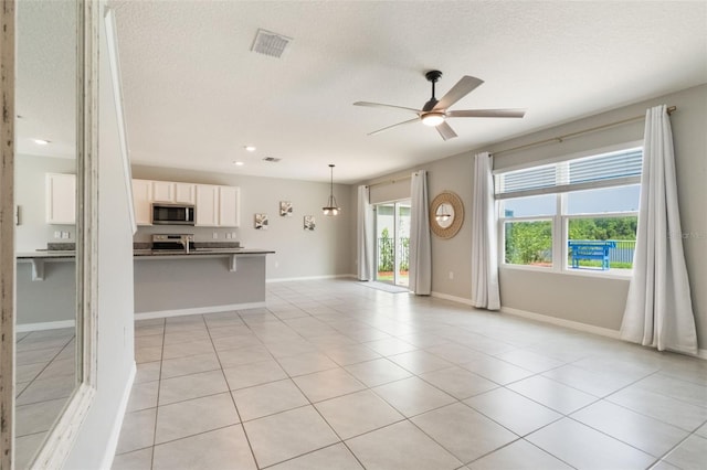 6808 Cranes Roost Rd, Harmony, FL 34773 - unfurnished living room with ceiling fan, a textured ceiling, light tile patterned flooring, and recessed lighting