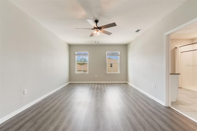 6808 Cranes Roost Rd, Harmony, FL 34773 - unfurnished room featuring wood finished floors, ceiling fan, and a textured ceiling