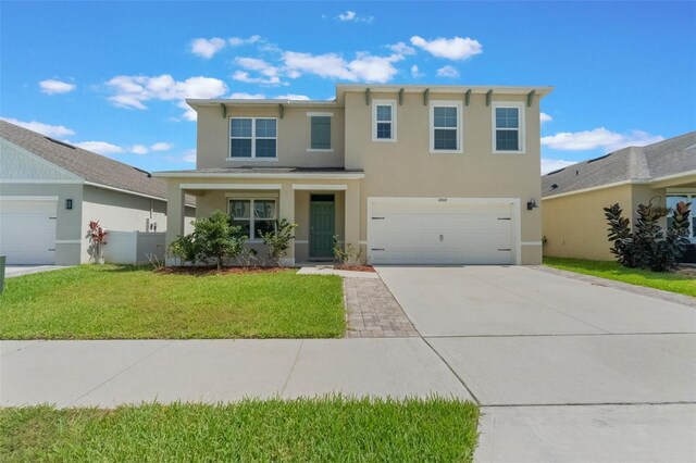 6808 Cranes Roost Rd, Harmony, FL 34773 - traditional-style home with stucco siding, driveway, a front yard, and a garage