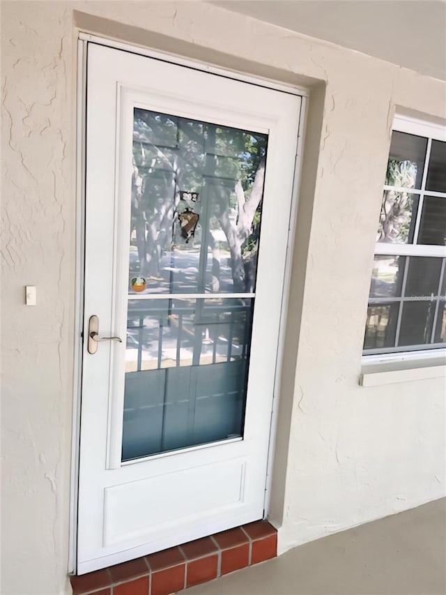 821 Patricia Ave Unit 202, Dunedin, FL 34698 - view of exterior entry featuring stucco siding