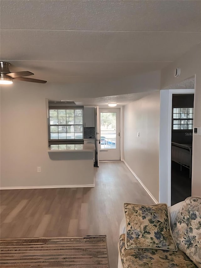 821 Patricia Ave Unit 202, Dunedin, FL 34698 - unfurnished living room featuring light wood-type flooring and a ceiling fan