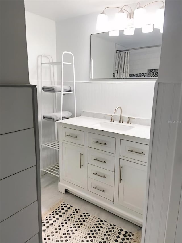 821 Patricia Ave Unit 202, Dunedin, FL 34698 - full bathroom with vanity, a shower with curtain, and a wainscoted wall
