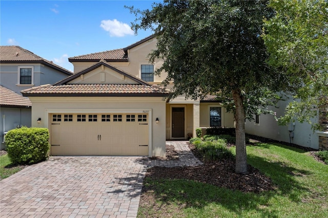9023 Shadow Mountain St, Davenport, FL 33896 - view of front of house with an attached garage, decorative driveway, stucco siding, and a tile roof